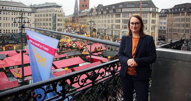 Mareike Engels steht auf dem Rathausbalkon vor der gehissten Flagge.