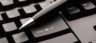 Symbolfoto von Kugelschreiber auf Computertastatur.
