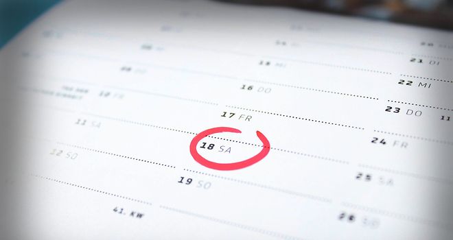 Das Symbolfoto zeigt einen Terminkalender auf dem in rot ein Tag umkreist ist.