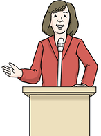 Frau steht vor einem Rednerpult und hält eine Rede.